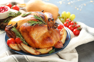 Delicious roasted turkey for traditional festive dinner on table