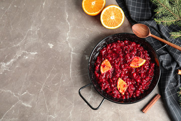 Flat lay composition with cranberry sauce in pan on table. Space for text