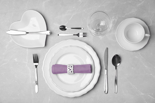 Stylish elegant table setting on grey background, top view