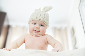 A newborn baby is lying on a soft bed.