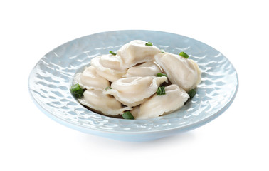 Plate of tasty dumplings served with green onion on white background