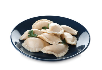 Plate of tasty dumplings served with parsley on white background