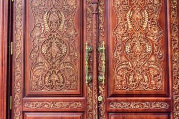 Fototapeta na wymiar Ancient Wooden Door with Golden Door Handle 