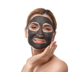 Beautiful woman with black mask on face against white background