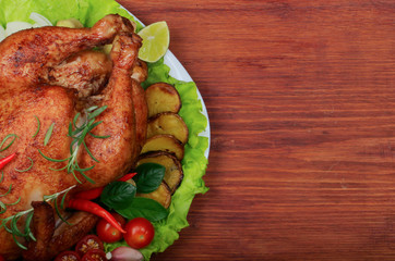 grilled chicken with spices on wooden background