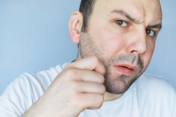 Obraz premium A man shaves in front a mirror. Shaving foam. Disposable razor.