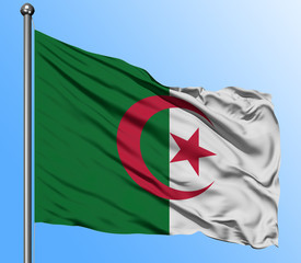 Algeria flag waving in the deep blue sky background. Isolated national flag. Macro view shot.