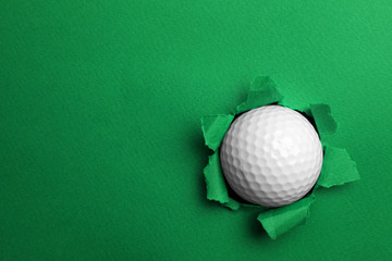 Torn color paper with golf ball, space for text. Sport equipment
