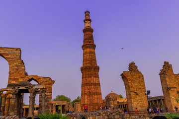 Fototapeta na wymiar The Qutub Minar - 73-metre tall tapering tower of five storeys, also spelled as Qutab Minar, is a minaret that forms part of the Qutb complex, a UNESCO World Heritage Site in Delhi, India