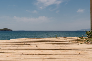 Fototapeta premium A wooden pathway leading to the beach, at the island of Andros, Cyclades, Greece