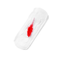 Menstrual pad and red feather on white background, top view. Gynecological care