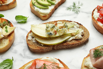 Many different tasty bruschettas on marble table