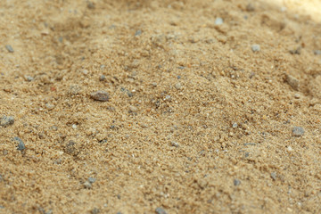 Fototapeta na wymiar Textured sandy soil surface as background, closeup