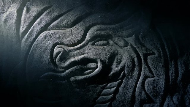 Shaft Of Light Reveals Old Dragon Stone Carving