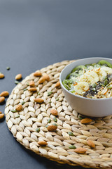 healthy Breakfast of oatmeal with fruit on a wicker napkin and almond