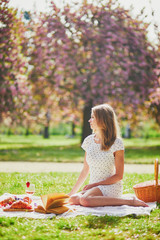 Beautiful young woman having picnic