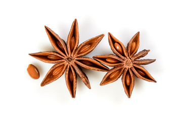 Star anise. Two star anise fruits with seed. Macro close up Isolated on white background with shadow, top view of chinese badiane spice or Illicium verum.