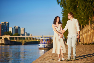 Fototapeta na wymiar Happy romantic couple in Paris, near the river Seine