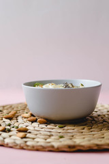 healthy Breakfast of oatmeal with fruit on a wicker napkin and almond