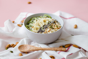 healthy Breakfast of oatmeal with fruit on a white napkin and almond