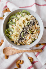 healthy Breakfast of oatmeal with fruit on a white napkin and almond