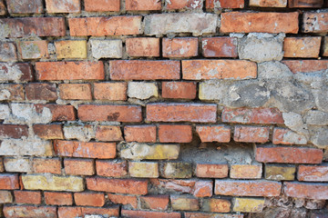 Fototapeta premium destroyed old brick in the old wall