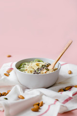 healthy Breakfast of oatmeal with fruit on a white napkin and almond