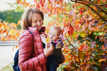 Woman and baby girl outdoors in park