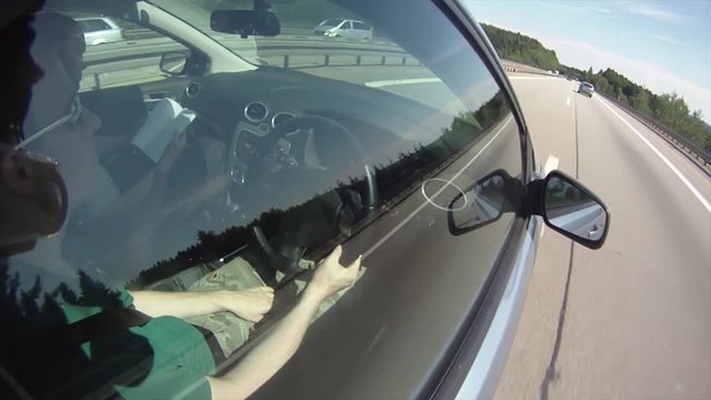 A highly stylized clip of a car speeding down the highway on the German autobahn. Highway window ungrade.d
