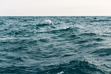 Naklejka na ściany i meble dark blue sea water background, waves of blue in black sea
