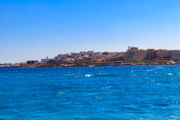 Fototapeta na wymiar Beautiful view of the coastline with houses and hotels in Hurghada, Egypt. View from Red sea