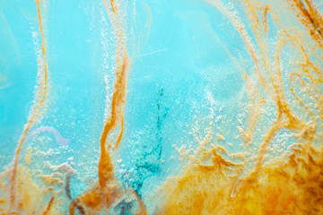 abstract texture. red and aquamarine background. stains of watercolor paint in water