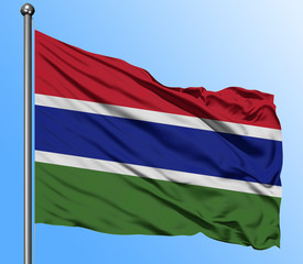 Gambia flag waving in the deep blue sky background. Isolated national flag. Macro view shot.
