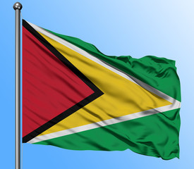 Guyana flag waving in the deep blue sky background. Isolated national flag. Macro view shot.