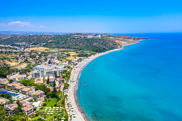 Pissouri. Cyprus. Pissouri beach panorama from a drone. Residential settlements and hotels in the valley at the mountains bottom. The Mediterranean blue lagoon. The Pissouri resort. Travel to Cyprus.