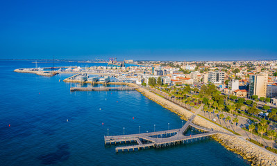Fototapeta na wymiar Limassol. Republic of Cyprus sea bay top view. Molos Limassol embankment. Quay piers lead to the sea. Berths for yachting. Mediterranean. The beaches in Cyprus. Travelling to Cyprus. Drone panorama.