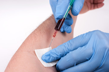 Tests blood Healthcare checkup. Nurse with blue rubber gloves using syringe suck blood at arm line...