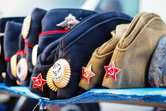Military caps with Soviet Union and Russian symbols on flea market