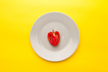 Fresh Tomato sliced in a plated on yellow background