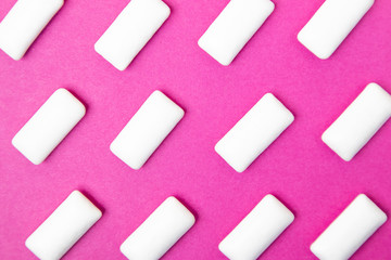 Bubble gum, white dragee on a bright pink background. Stylish photo, minimalism, design, flat lay, top view.