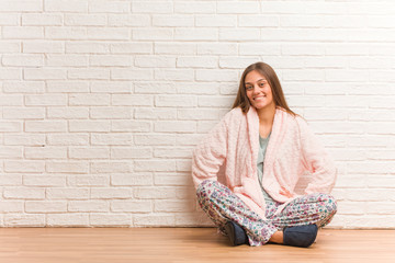 Young woman wearing pajama with hands on hips