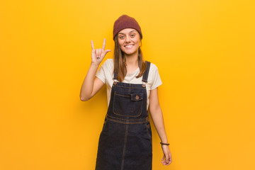 Young hipster woman doing a rock gesture