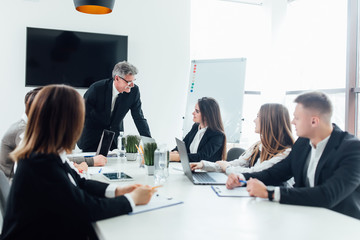 Speaker standing and lecturing on business conference in meeting hall ..Business concept.