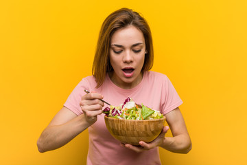 Vegan young woman eating a fresh and delicious salad.