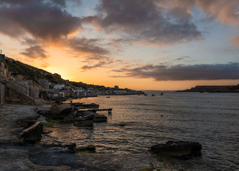 Numerous boat houses at the rocky beach