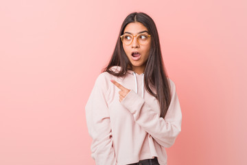 Young pretty arab woman wearing a casual sport look pointing to the side