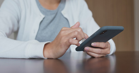 Woman use of mobile phone at home