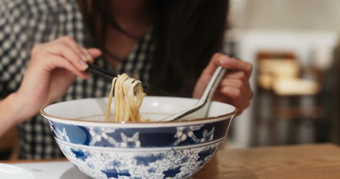 Woman Eat Noodles In Restaurant