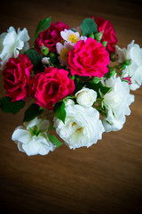 bouquet of beautiful red and white roses on a wooden