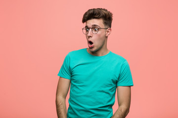 Fototapeta premium Young cool caucasian man being shocked because of something she has seen.